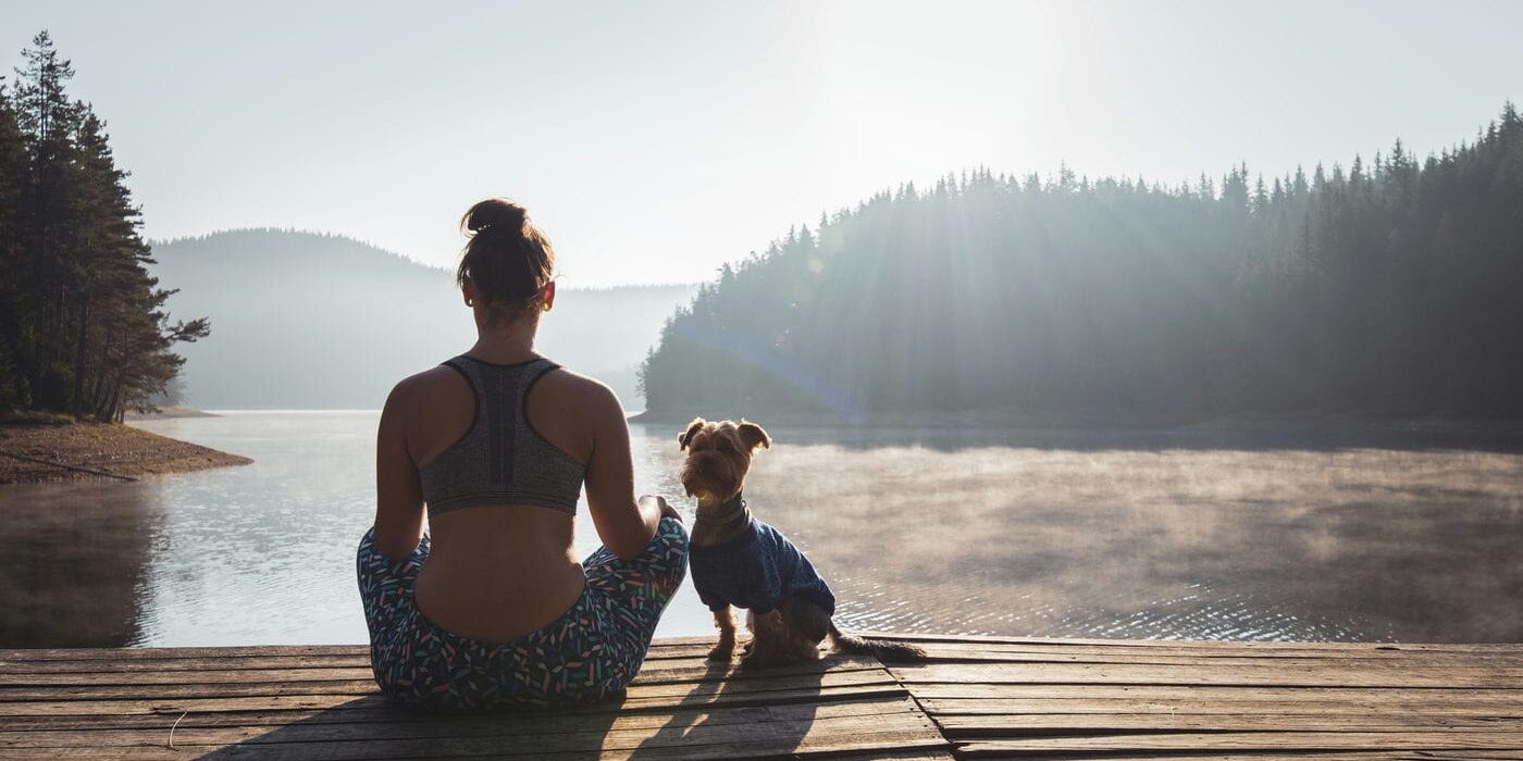 woman meditating by a lake in ontario canada